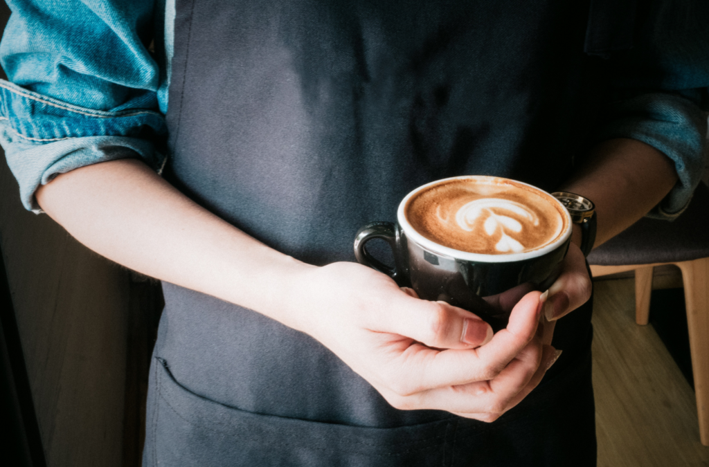 Barista holding coffee