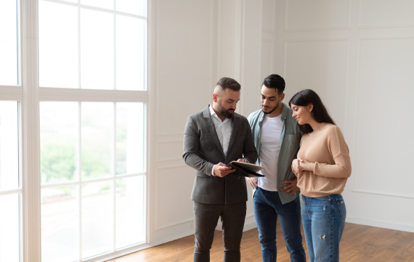 An image of a couple and mortage broker inside a home